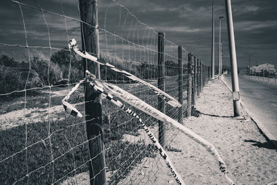 Fence on field against sky