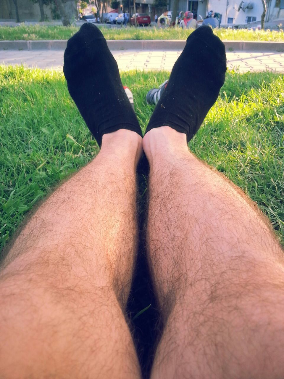 low section, grass, person, lifestyles, personal perspective, leisure activity, field, unrecognizable person, men, shoe, part of, human foot, relaxation, day, grassy