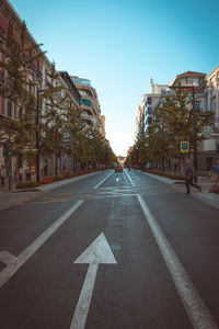 Road by city against clear sky