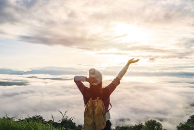 Man standing against sky at sunset