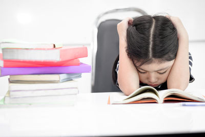 Portrait of young woman sleeping on table