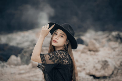 Portrait of beautiful young woman wearing hat