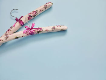 High angle view of pink flower on table against white background