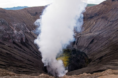 Smoke emitting from volcanic mountain