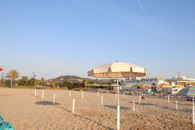 Beach umbrellas against clear sky