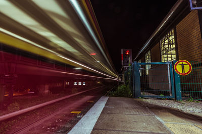 Speeding blurred train at railway station