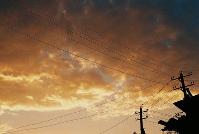 Low angle view of electricity pylon against sky