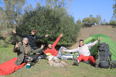 Portrait of happy friends during camping