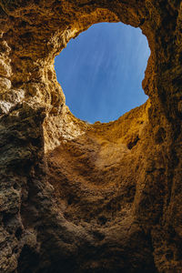 Low angle view of rock formation against sky