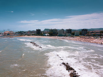 Scenic view of beach and buildings against sky