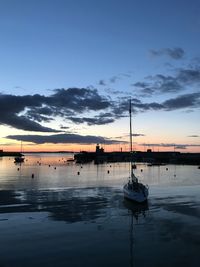 Sailboats in marina at sunset