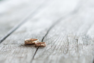 Close-up wedding rings on the wooden table