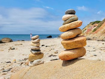 Stacked rocks on beach.