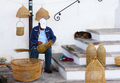 Man working on basket for sale at market