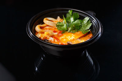 High angle view of food in bowl against black background