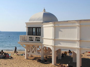 Built structure on beach against clear sky