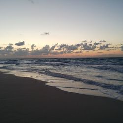 Scenic view of beach against sky during sunset