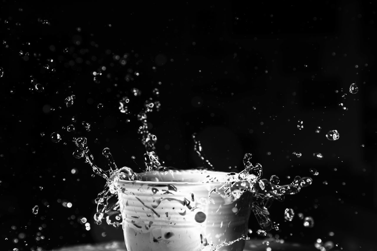 CLOSE-UP OF WATER SPLASHING ON GLASS