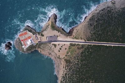 Aerial view of built structure by sea