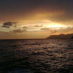 View of sea against cloudy sky during sunset