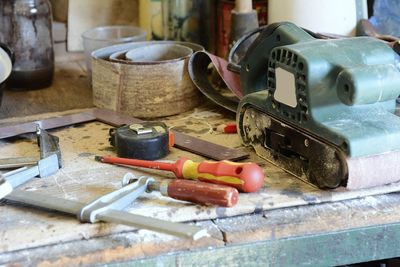 Close-up of work tools on table at workshop