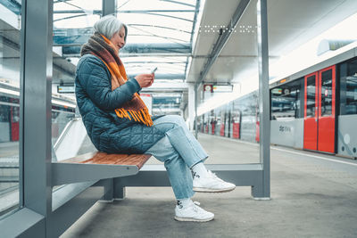 Side view of woman using mobile phone