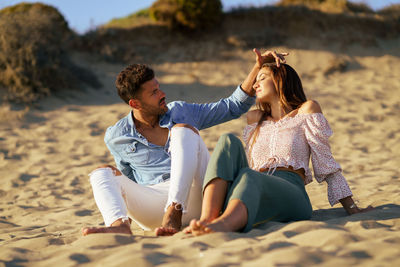 Young couple sitting on beach