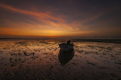 Scenic view of beach against sky during sunset