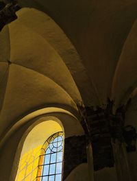 Low angle view of old building seen through window