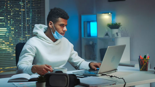 Young woman using laptop at office