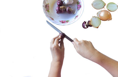 Midsection of woman holding ice cream against white background