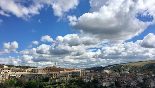 Buildings in city against sky