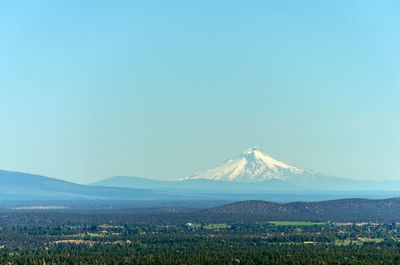 Scenic view of landscape with mt hood in background against clear blue sky