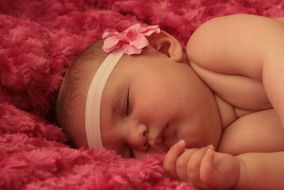 Close-up of baby sleeping on bed