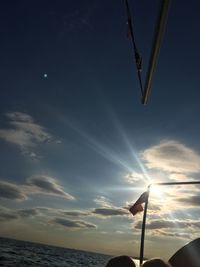 Low angle view of silhouette flag against sky during sunset