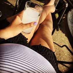 Low section of woman drinking glass