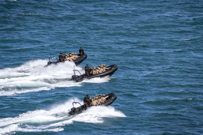 Three boats with spanish marines in the bay of gijon, asturias