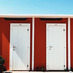 Beach huts against clear blue sky