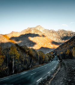 Road passing through mountains against sky