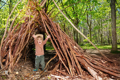 Full length of woman standing in forest