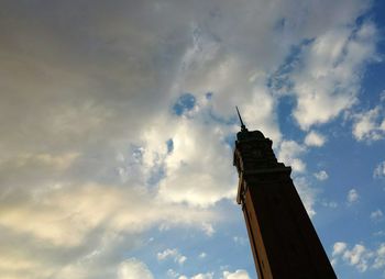 Low angle view of tower against cloudy sky