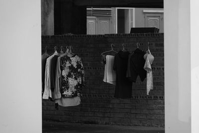 Clothes drying against wall in building