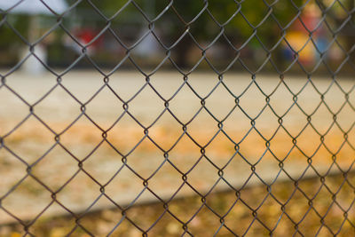 Close-up of soccer field seen through chainlink fence