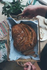 High angle view of person holding bread in plate