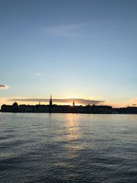 Scenic view of river against sky during sunset