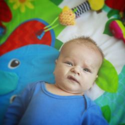 Portrait of cute baby lying on bed