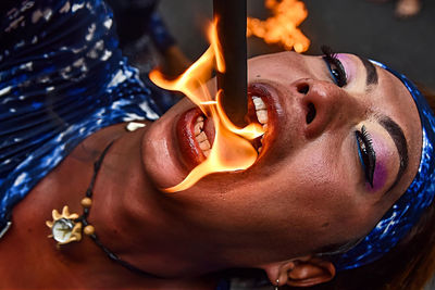 Close-up of young man eating fire
