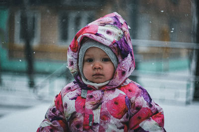 Portrait of cute girl standing in snow