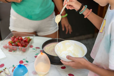 High angle view of people preparing food on table