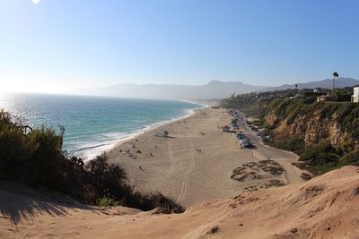 Scenic view of beach against clear blue sky